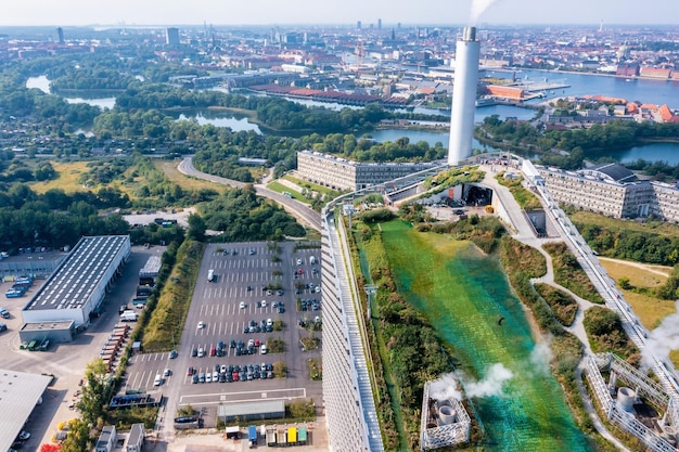 a city view from the air with a green grass and a building in the background