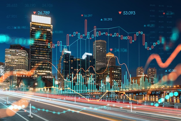 City view panorama of Boston Harbor and Seaport Blvd at night time Massachusetts Financial downtown Glowing FOREX graph hologram The concept of international trading and fundamental analysis