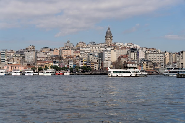 A city with a large building in the middle and a boat in the water