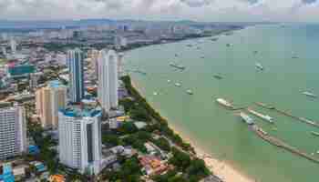 Photo a city with tall buildings and a beach and a city in the background