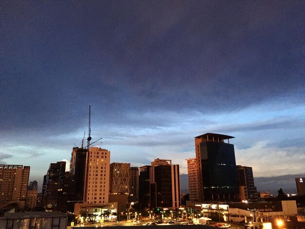 Cityscape against cloudy sky