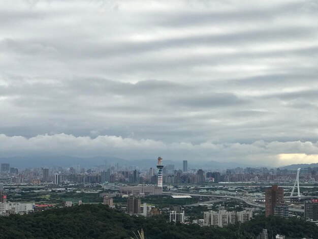 Cityscape against cloudy sky