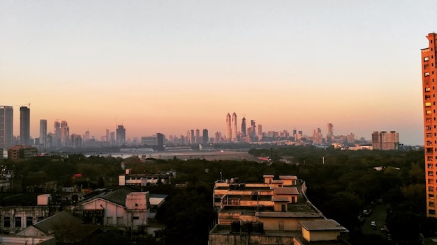 Photo cityscape against sky during sunset