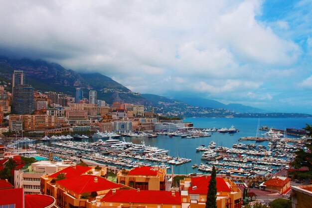 Cityscape by sea against sky