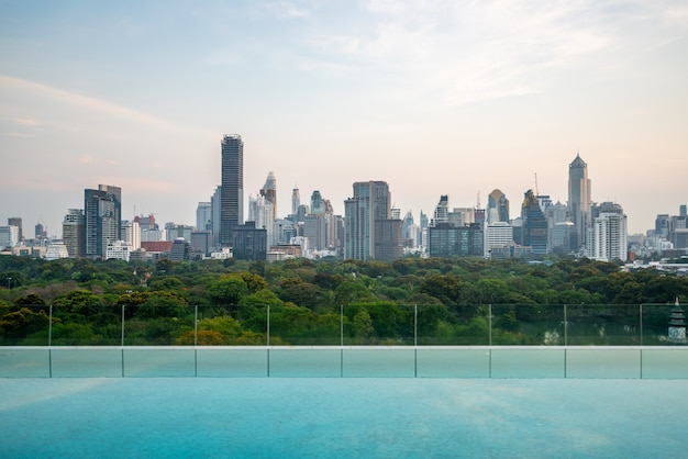 Cityscape and high-rise buildings in metropolis city with water reflection