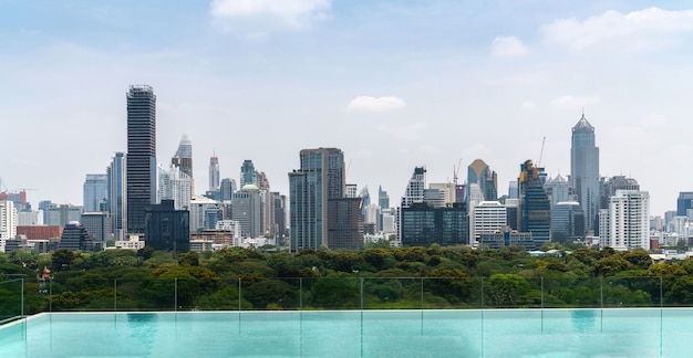 Cityscape and high-rise buildings in metropolis city with water reflection