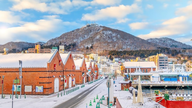 Cityscape of the historic red brick warehouses and Mount Hakodate  at twilight in Hakodate, Hokkaido Japan in winter