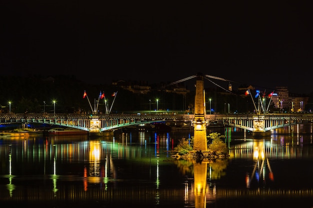 Cityscape of Lyon, France with reflections in the water at night