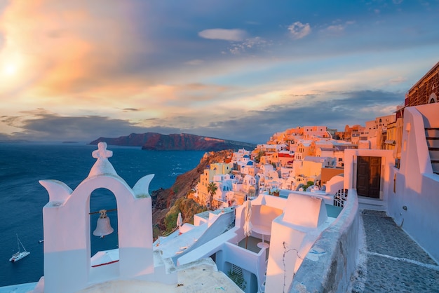 Cityscape of Oia town in Santorini island, Greece. Panoramic view at the sunset.