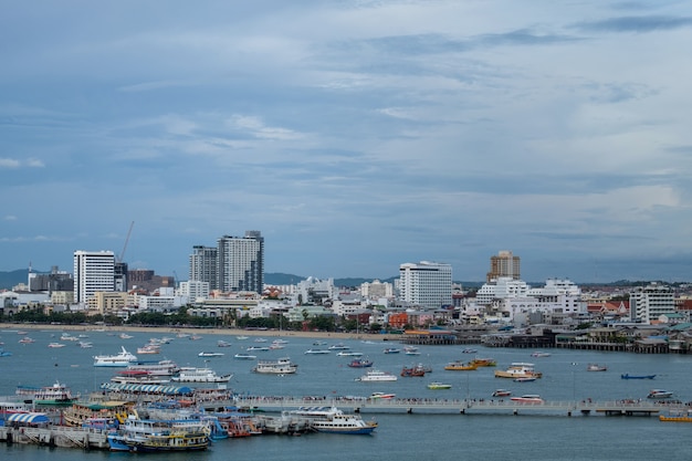 Cityscape of Pattaya and beach with speed boat in Thailand.