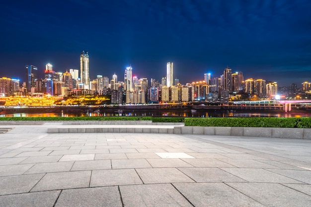 Cityscape and skyline of downtown near water of chongqing at night