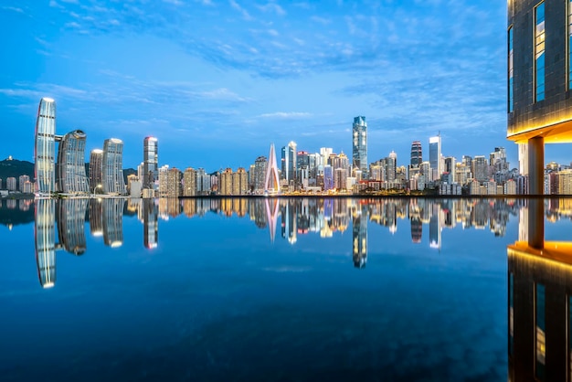 Cityscape and skyline of downtown near water of chongqing at night