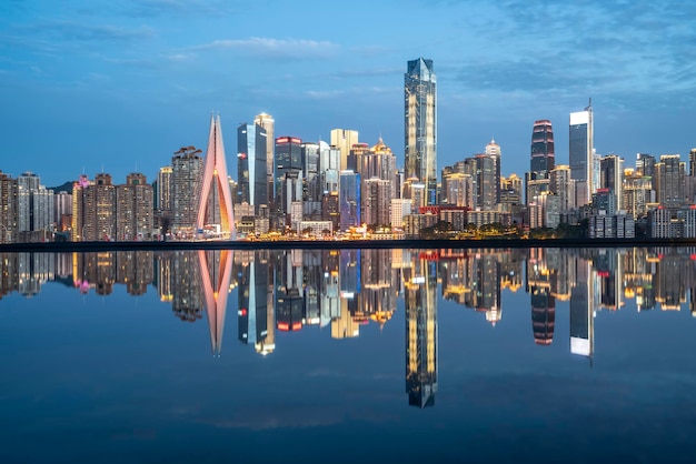 Cityscape and skyline of downtown near water of chongqing at night