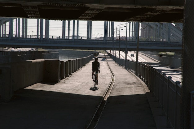 Cityscape at sunrise with a cyclist