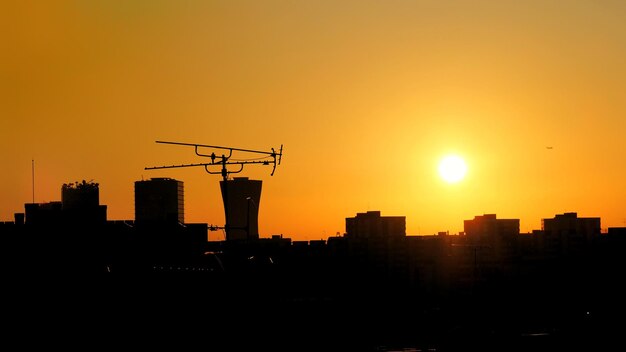 Cityscape at sunset with building silhouettes