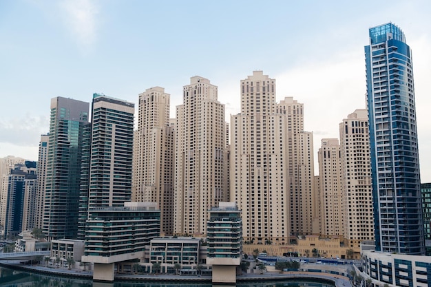 cityscape, travel, tourism and urban concept - Dubai city business district with skyscrapers and bridge