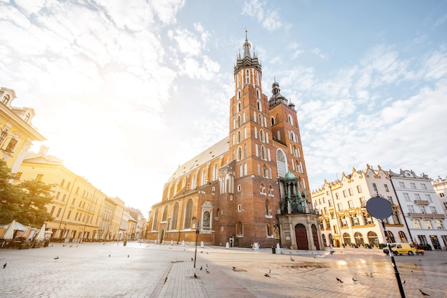 Cityscape view on the Market square with famous saint Marys Basilica during the sunrise in Krakow, Poland