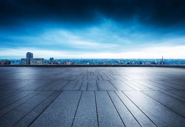 A cityscape with a building in the background with a blue sky and lights on it