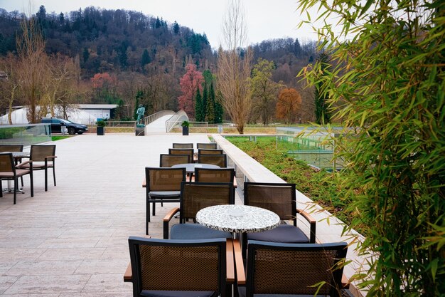 Cityscape with street cafe in the park in Celje old town in Slovenia. Architecture in Slovenija. Travel. Tables and chairs.