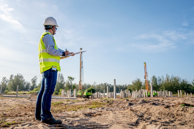 Civil engineer inspection piling work at infrastructure construction site 