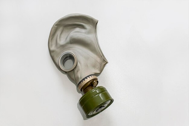 Civil or military gas mask on white surface