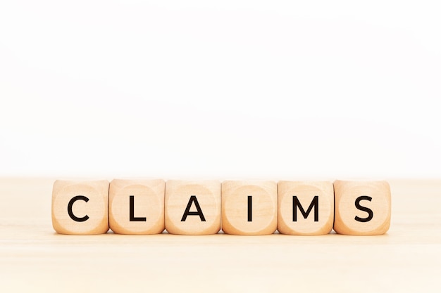 Claims word on wooden block shape Copy space White background