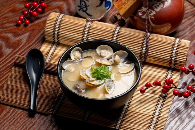 Clam Miso Soup in a dish with chopsticks isolated on mat side view of taiwan food