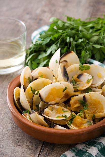 Clams with marinera sauce Almejas a la marinera Spanish recipe on wood table