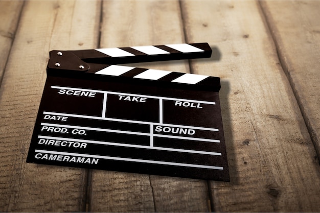 Clap board on wooden background