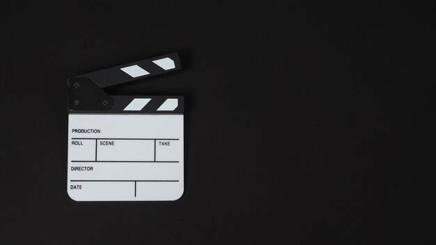 Clapper board or movie slate and chair. It is use in video production , movie ,film, cinema industry on black background.