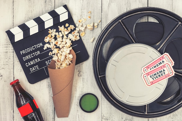 Photo clapperboard, movie reel and popcorn