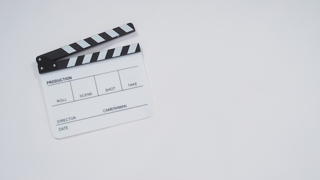 Clapperboard or movie slate use in video production, film and  cinema industry. It's white color on paper background.