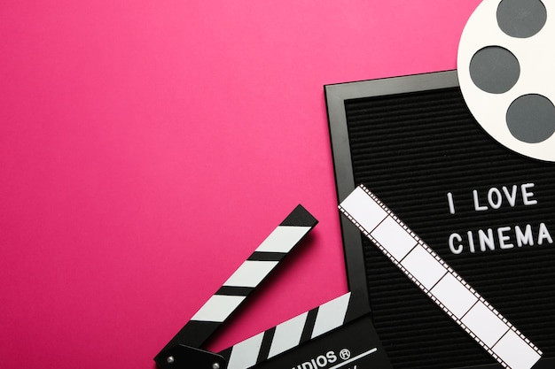 Photo clapperboard reel film and letter board on pink background space for text