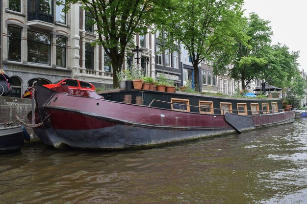 Clasic boat in  one of the canals of Amsterdam.