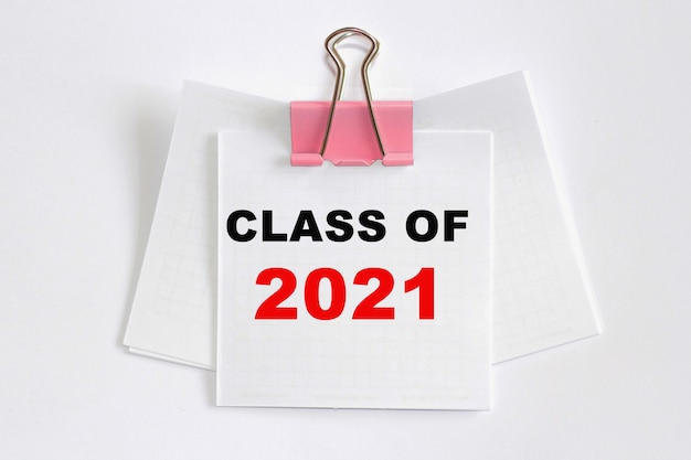 CLASS OF 2021 . A small piece of paper clamped by binder clip to a wire . The concept of business and education.