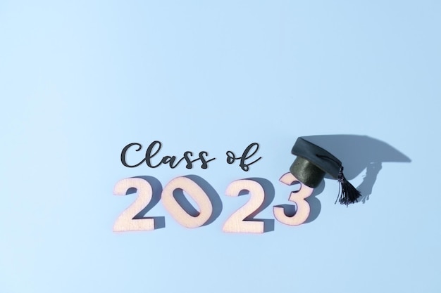 Photo class of 2023 concept numbers 2023 with black graduated cap on colored background