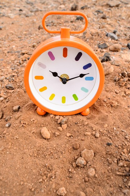 Classic Analog Clock In The Sand On The Rock Desert