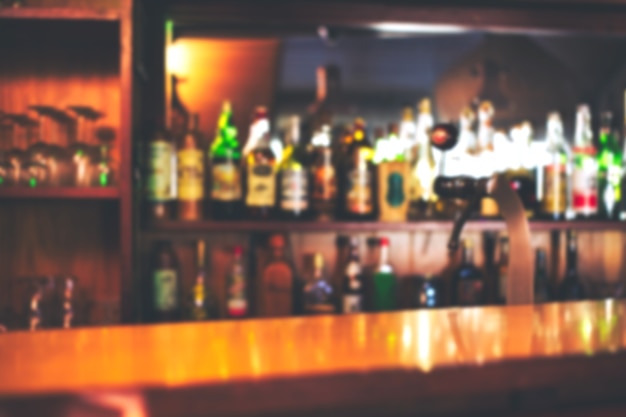 Classic bar counter with bottles in blurred background, copy space or space for text. colorful defocused background restaurant or cafe close-up