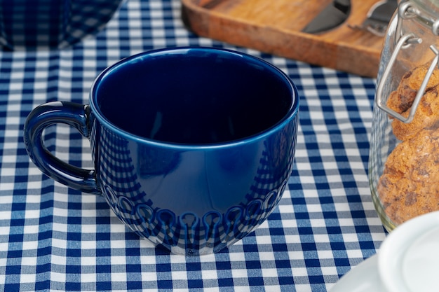 Classic blue empty ceramic tea cup on kitchen table close up