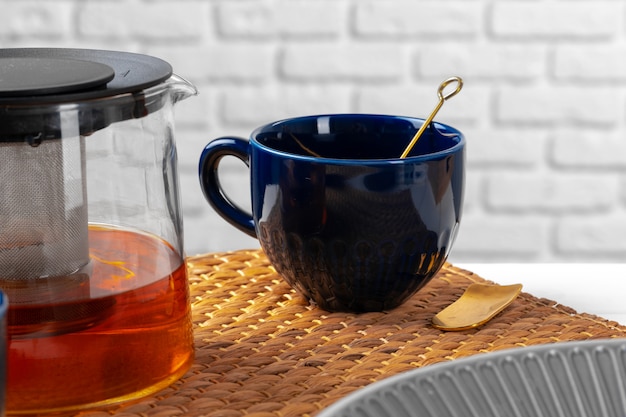 Classic blue empty ceramic tea cup on kitchen table close up