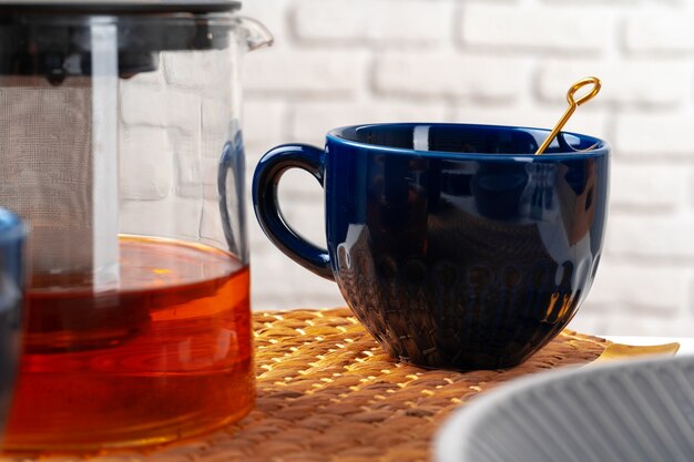 Classic blue empty ceramic tea cup on kitchen table close up