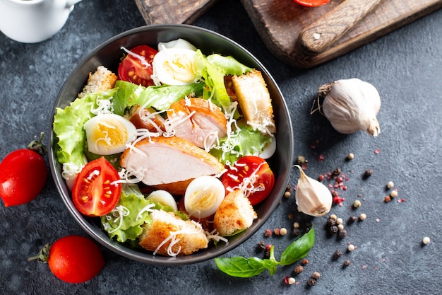 Classic caesar salad with chicken fillet and parmesan cheese. Chicken Caesar Salad. Top view, copy space.