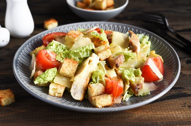 Classic Caesar salad with chicken, tomato and sauce