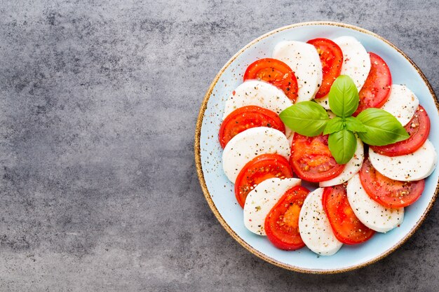 Classic caprese salad. Mozzarella tomatoes and  Basilikum.