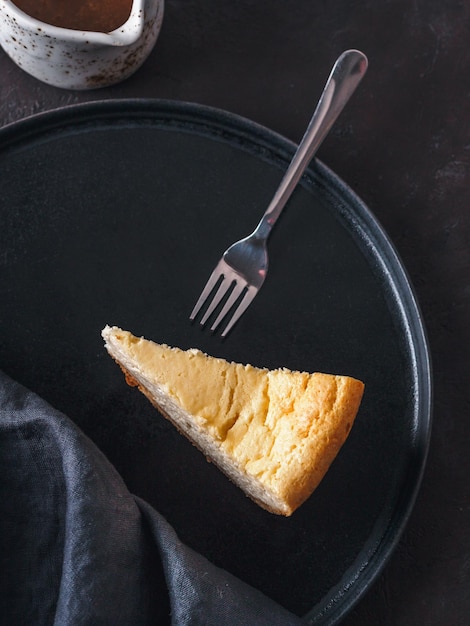 Classic Cheesecake on dark background Top view