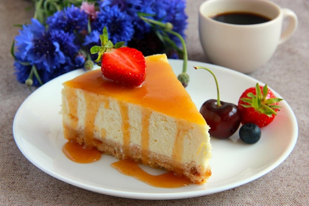 Classic cheesecake New York with salted caramel sauce, berries and flowers