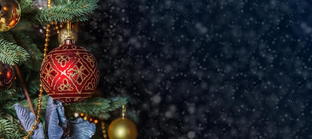 Фото Классическое рождественское украшение новогодняя елка рождественская елка с золотыми украшениями орнаменты в классическом стиле еловые ветки с расфокусированными огнями абстрактный темный фон сочельник дома