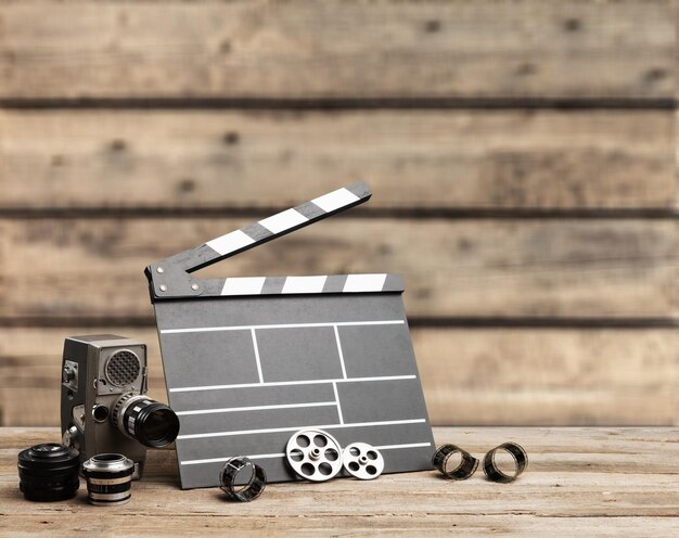 Classic clapperboard and lenses on brown