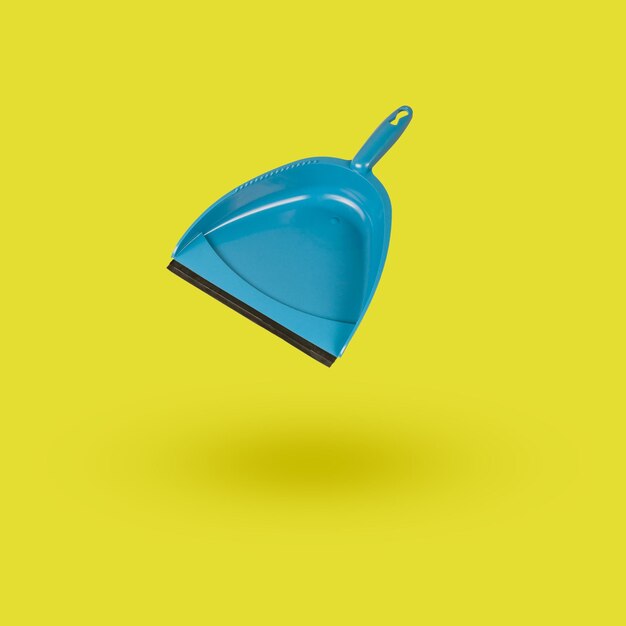 Classic dustpan on a yellow background Minimal cleaning concept Flat lay