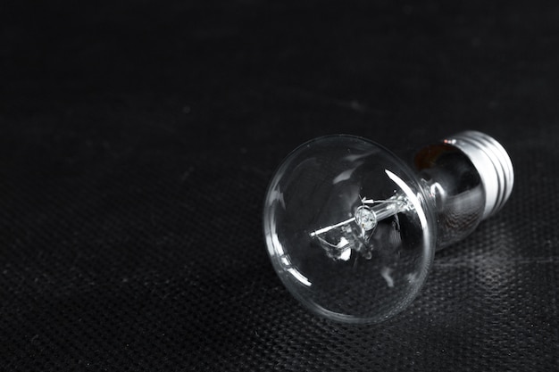 A classic Edison light bulb on dark with space for text